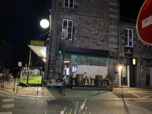 a building on a street corner at night at Home SAINT MICHEL-restaurant Chicken cabana in Pontorson