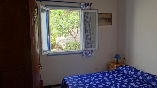 a bedroom with a bed and a window at Residence Funtanella in Sagone