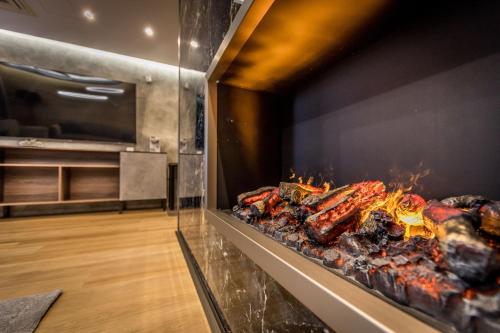 a row of meat cooking on a grill at Kalvín Restaurant & Pension in Rastislavice