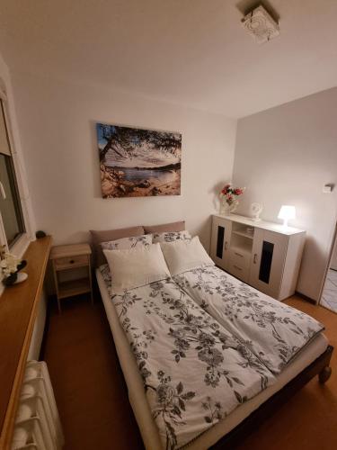 a small bedroom with a bed and a desk at Kessi in Ustka