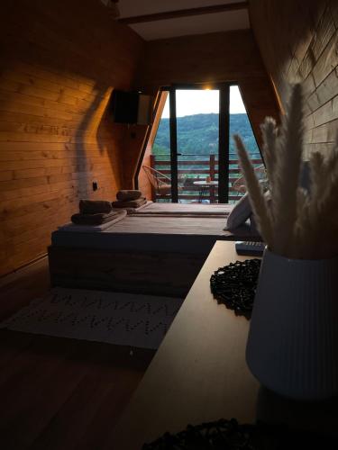 a room with two beds and a vase with a plant at Vila Grujic in Vrdnik