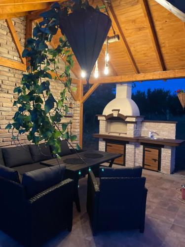 a patio with a table and chairs and a fireplace at Vila Grujic in Vrdnik