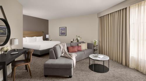 a hotel room with a bed and a couch and a table at Hyatt Regency Sonoma Wine Country in Santa Rosa