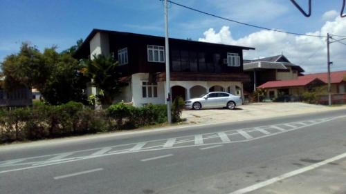 ein Auto, das vor einem Haus auf einer Straße parkt in der Unterkunft Homestay Kuala Terengganu One Stop 1 in Kuala Terengganu