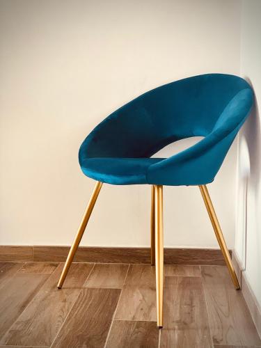 a blue chair with wooden legs in a room at A casa di Alberta B&B Relais in Rotondella