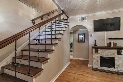 a spiral staircase in a home with a fireplace at The Old Downtown Historic Grand Prairie House home in Grand Prairie