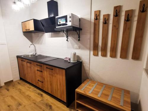 a small kitchen with a sink and a microwave at Plitvice Story in Plitvička Jezera