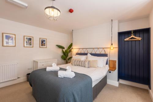a bedroom with a bed with towels on a table at The Servant’s Quarters in Whitby