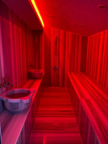 a red bathroom with two sinks and red lights at FULL MÜSTAKİL GÖL MANZARALI HAVUZLU VİLLA- BTK01 in Sapanca