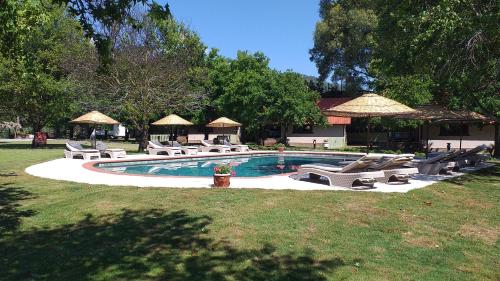 a swimming pool with lounge chairs and a fire hydrant at Gaia Koru Bungalows in Ortaca