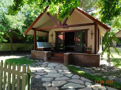 a small cottage with a porch and a fence at Dalyan Riverside Private Gaia Koru Bungalows with Swimming Pool Adults Only in Ortaca