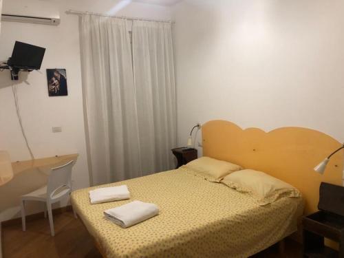 a bedroom with a bed with two towels on it at B&B Brezza Marina in San Benedetto del Tronto