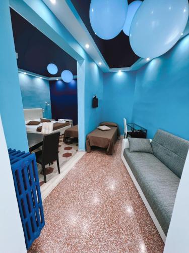 a blue living room with a couch and a table at DEAS B&B in Trani