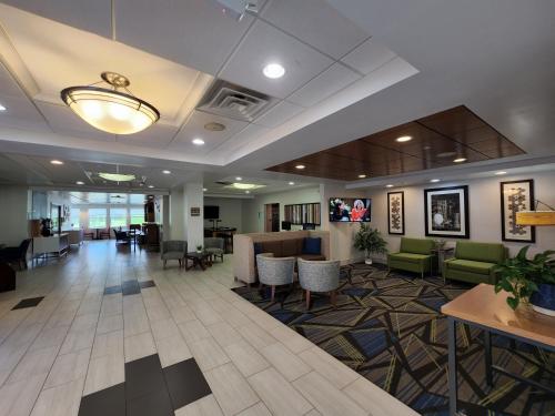 a lobby of a hospital with tables and chairs at Holiday Inn Express Hotel & Suites Rochester by IHG in Rochester