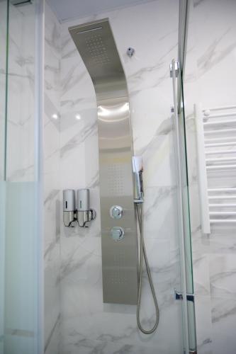 a shower with a glass door in a bathroom at Relax House Barcelone in Sant Esteve Sesrovires