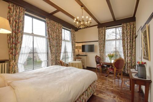 een hotelkamer met een bed en een tafel en stoelen bij Hotel Pension 't Huys Grol in Renesse