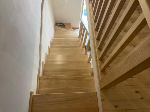 a wooden staircase in a house with wooden floors at Valeria’s Apartments in Sinarádes