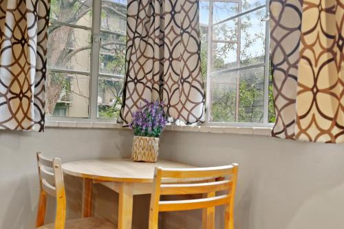 a table and chairs in a room with windows at 1147 Vine St in Denver