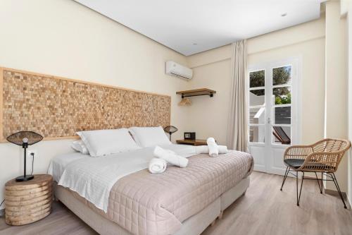 a bedroom with a bed with two stuffed animals on it at Ethereal Stay in Spetses