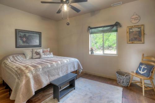 a bedroom with a bed and a window and a chair at Pine River Cabin 2 BR Bayfield in Bayfield