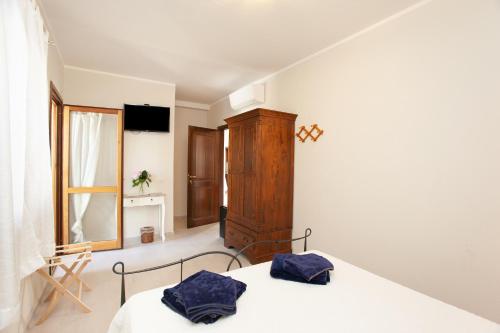 Ένα ή περισσότερα κρεβάτια σε δωμάτιο στο Lu Lioni Rooms