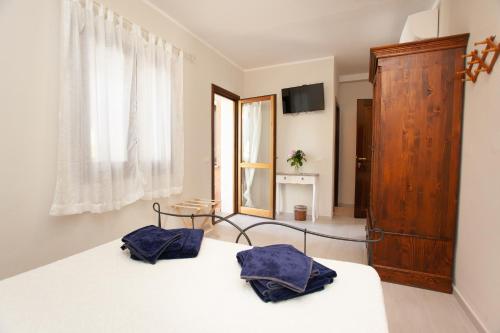 Postel nebo postele na pokoji v ubytování Lu Lioni Rooms