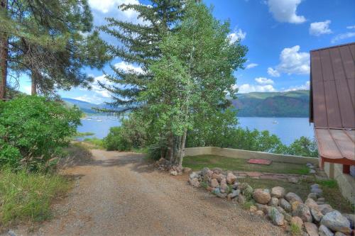a dirt road next to a house and a lake at Waterfront Cabin on Vallecito Lake in Vallecito