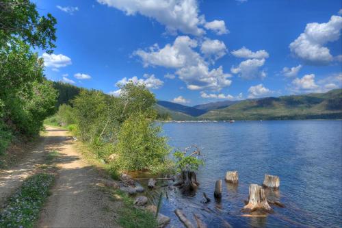a path next to a lake with mountains in the background at Waterfront Cabin on Vallecito Lake in Vallecito