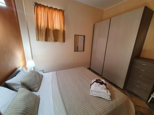 a bedroom with a bed with a purse on it at Casa La Ferula apt3 vicino al mare e Taormina con terrazza panoramica in SantʼAlessio Siculo