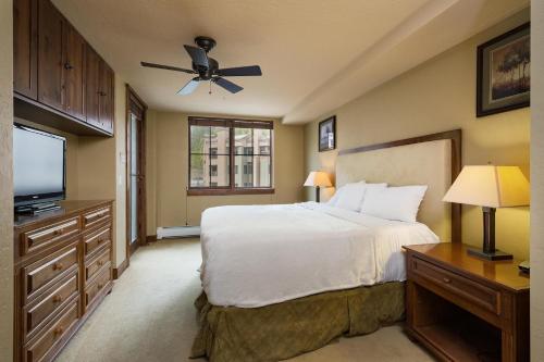 a bedroom with a bed and a flat screen tv at Purgatory Lodge Unit 306 in Durango Mountain Resort