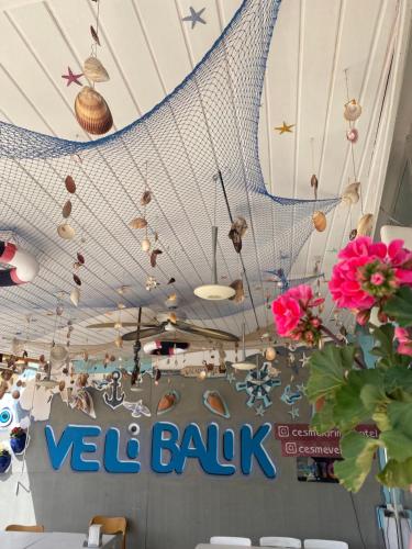 a restaurant with a white ceiling with a net at Larimar Hotel Cesme in Çeşme