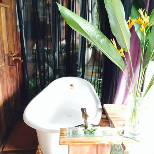 a bathroom with a sink and a vase with flowers at 秘密花園Design Villas in Yuchi