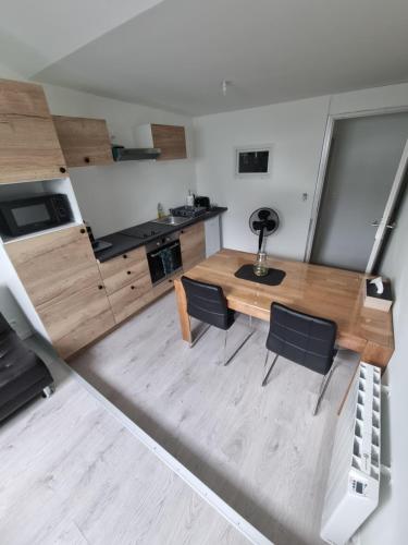 an overhead view of a kitchen with a table and chairs at THELNA elya in Bray-Dunes