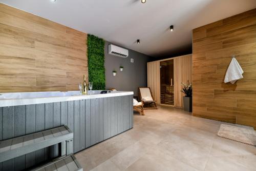 a bathroom with a large tub and a sink at Vila Nela in Benkovac