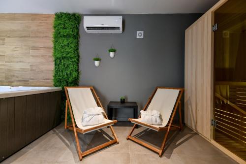 two folding chairs sitting in a room with a kitchen at Vila Nela in Benkovac