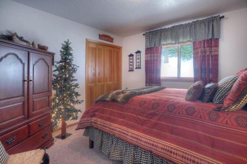 a bedroom with a christmas tree next to a bed at Seven Pines Cabin in Vallecito Lake Area in Bayfield