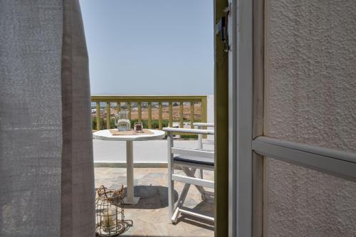 a view of a table and chair from a window at Vavoulas Village in Mikri Vigla