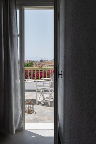 an open door to a patio with a table and chairs at Vavoulas Village in Mikri Vigla
