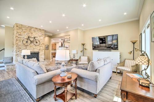 a living room with two couches and a fireplace at Renovated North Bend Cottage Near Eateries! in North Bend