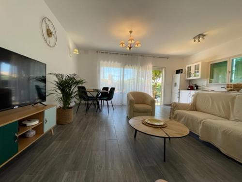 un salon avec un canapé et une table dans l'établissement 2 pièces en RDJardin avec 2 grands Terrasses, à Antibes