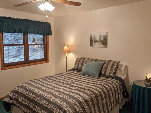 a bedroom with a bed and a ceiling fan at Vallecito Family Retreat in Bayfield