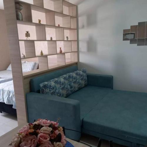 a living room with a couch and a table at Residencial Flats Botanicus 1 in Olímpia