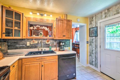 a kitchen with wooden cabinets and a sink at Dtwn Elizabethtown Home with Fire Pit and Gas Grill! in Elizabethtown