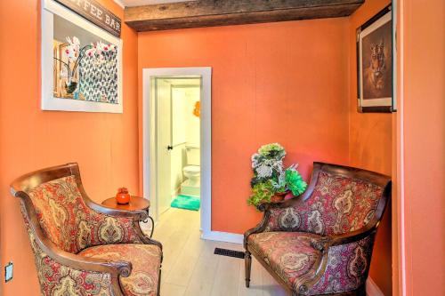 two chairs in a hallway with orange walls at Dtwn Elizabethtown Home with Fire Pit and Gas Grill! in Elizabethtown