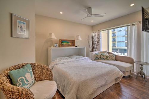 a bedroom with a bed and a chair and a window at Family-Friendly Brigantine Condo Near Beach! in Brigantine