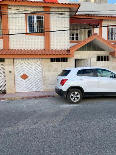 a white car parked in front of a house at Marbella1 in Los Frailes