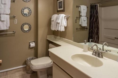 a bathroom with a sink and a toilet and a mirror at Tamarron Lodge Loft 510 in Durango
