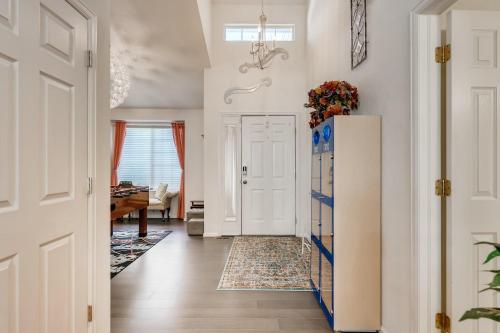 a hallway with a white door and a refrigerator at 342 English Sparrow Dr in Highlands Ranch