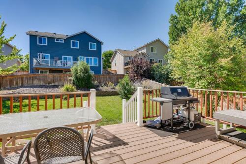 a wooden deck with a picnic table and a grill at 342 English Sparrow Dr in Highlands Ranch