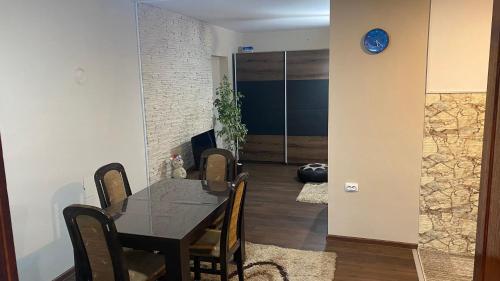 a dining room with a black table and chairs at Arni apartments in Donja Vrežina